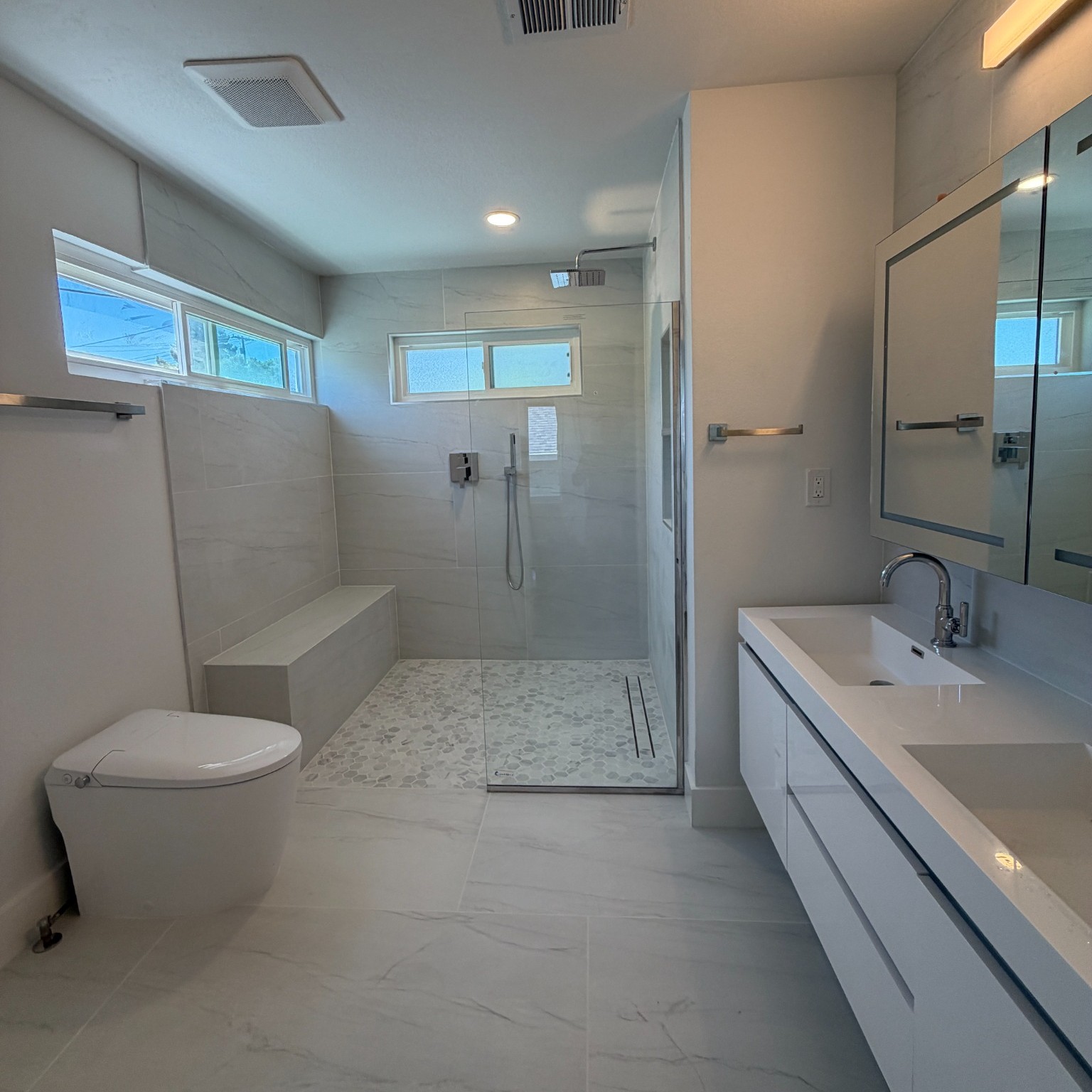 Primary bathroom in Castro Valley three-bathroom remodel with walk-in shower and double vanity